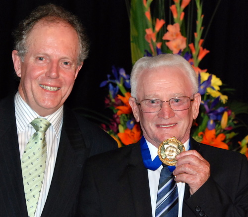 Henry Pullen displays his Edgar Tatlow Medal accompanied by Tasracing board member Dean Cooper
