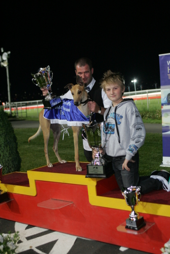 Banger Harvey with trainer Mick Stringer and the late Bob Brown's son Ross Brown who presented the trophy
