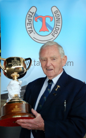 Former great jockey Jim Johnson holding the 2011 Emirates Melbourne Cup
