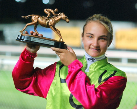 Apprentice Georgie Catania proudly shows off her trophy for guiding Heartbreak Lass to victory in the Tasmanian heat of the National Apprentices series
