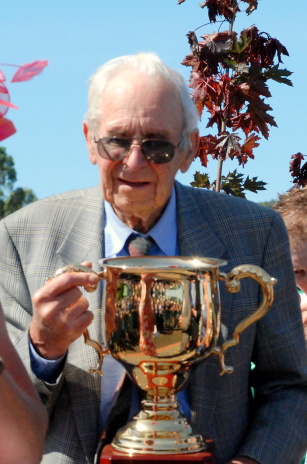 Jim Osborne holding the 2010 Devonport Cup won by his mare With Decorum
