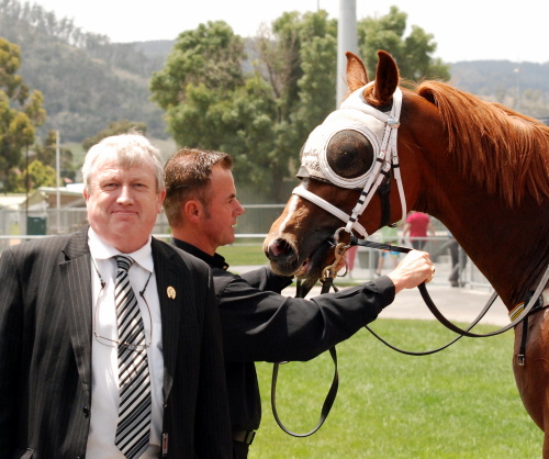 Part-owner Andrew Scanlon looks pleased as trainer Gary White holds Speedo Zap after the win
